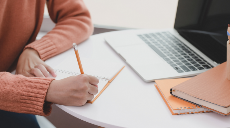 person-writing-on-white-paper-featured